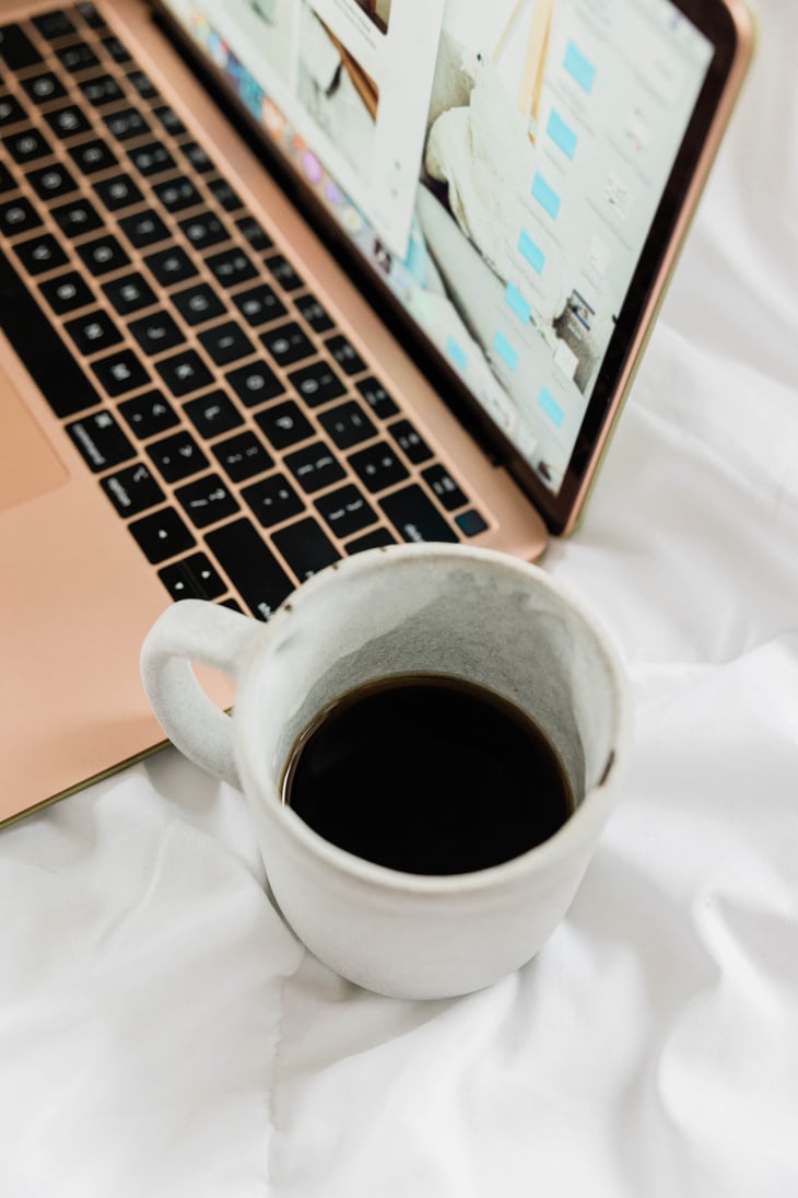 Laptop and Coffee on Bed